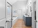 Bright main bathroom featuring a double vanity, a soaking tub, and a glass shower at 300 Tarragon Dr, Fayetteville, GA 30215