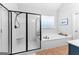 Main bathroom with walk-in shower, soaking tub, and terra cotta tile flooring at 300 Tarragon Dr, Fayetteville, GA 30215