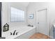 Main bathroom soaking tub with tile floor, decor, and a soaking tub at 300 Tarragon Dr, Fayetteville, GA 30215