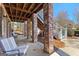 Covered outdoor patio area with brick columns, wooden ceiling, and view of backyard at 300 Tarragon Dr, Fayetteville, GA 30215