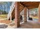 Covered patio with brick columns, outdoor grill, and staircase to the backyard at 300 Tarragon Dr, Fayetteville, GA 30215