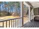 Relaxing porch with comfortable seating overlooks the expansive backyard and wooded landscape at 300 Tarragon Dr, Fayetteville, GA 30215
