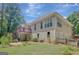Two-story home featuring a spacious wooden deck and an open backyard perfect for outdoor activities at 140 Rockglen Ct, Fayetteville, GA 30215