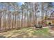 Inviting backyard with a wooden fence, an outdoor seating area and mature trees at 140 Rockglen Ct, Fayetteville, GA 30215