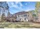 Well-maintained backyard with a deck, patio seating and mature trees at 140 Rockglen Ct, Fayetteville, GA 30215