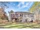 Backyard with a wooden deck, a patio and mature trees at 140 Rockglen Ct, Fayetteville, GA 30215
