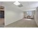 A carpeted basement space with natural light, featuring two chairs and a small table by a window, creating a cozy atmosphere at 140 Rockglen Ct, Fayetteville, GA 30215
