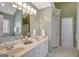 This bathroom features a double sink vanity, neutral paint, and access to the shower room at 140 Rockglen Ct, Fayetteville, GA 30215
