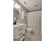 This bathroom features a modern vanity, round mirror, and a shower with patterned curtain at 140 Rockglen Ct, Fayetteville, GA 30215