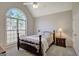 This bedroom features a large arched window, neutral paint, and a ceiling fan at 140 Rockglen Ct, Fayetteville, GA 30215