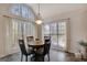 Dining area with large windows offering ample natural light and modern light fixture at 140 Rockglen Ct, Fayetteville, GA 30215