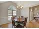 Dining room with hardwood floors, arched window, and modern lighting at 140 Rockglen Ct, Fayetteville, GA 30215