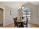 Dining room with hardwood floors, arched window, and chandelier at 140 Rockglen Ct, Fayetteville, GA 30215