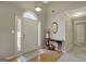 Charming entryway with wood floors, console table, and arched transom window at 140 Rockglen Ct, Fayetteville, GA 30215