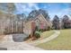 Two-story home with a well-kept lawn, brick accents, and a three car garage at 140 Rockglen Ct, Fayetteville, GA 30215
