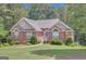 Charming brick home with manicured lawn and symmetrical landscaping at 140 Rockglen Ct, Fayetteville, GA 30215