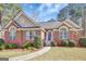 Charming brick home with well-maintained landscaping and a welcoming front entrance at 140 Rockglen Ct, Fayetteville, GA 30215