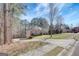 Spacious home with a long driveway, complemented by a well-manicured lawn and mature trees at 140 Rockglen Ct, Fayetteville, GA 30215