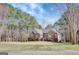 Beautiful single-story home with a brick facade, green lawn and mature trees at 140 Rockglen Ct, Fayetteville, GA 30215