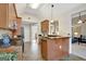 Modern kitchen with stone countertops, wood cabinets, and stainless-steel appliances at 140 Rockglen Ct, Fayetteville, GA 30215
