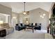 Open living room with neutral walls, vaulted ceiling, and views to dining and kitchen at 140 Rockglen Ct, Fayetteville, GA 30215