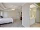 This main bedroom has a tray ceiling, neutral walls, and a view into the ensuite bath area at 140 Rockglen Ct, Fayetteville, GA 30215