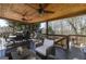 Covered back deck featuring wood ceilings, comfortable seating, and picturesque views of the private backyard at 149 Crown Glen Way, Stockbridge, GA 30281