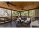 Spacious covered back porch with wood ceiling, comfortable seating, and a view of the private backyard at 149 Crown Glen Way, Stockbridge, GA 30281