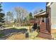 Private backyard featuring a large deck, lush lawn, and mature trees, perfect for entertaining at 149 Crown Glen Way, Stockbridge, GA 30281
