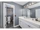 Bathroom featuring gray walls, dual sinks, white cabinets, and tile floors at 149 Crown Glen Way, Stockbridge, GA 30281