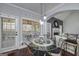 Dining area features a glass table, decorative lighting, and views of the fireplace in the living room at 149 Crown Glen Way, Stockbridge, GA 30281