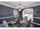 Formal dining room with large window, hardwood floors, and chandelier at 149 Crown Glen Way, Stockbridge, GA 30281