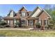 Charming brick home with manicured lawn, mature landscaping, and inviting front entrance at 149 Crown Glen Way, Stockbridge, GA 30281