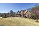 Stately brick home features a well-manicured front yard, mature landscaping, and classic architectural details at 149 Crown Glen Way, Stockbridge, GA 30281