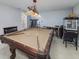Spacious game room featuring a pool table, popcorn machine, and a decorative light fixture at 149 Crown Glen Way, Stockbridge, GA 30281