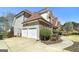 Attached two-car garage with extra space, complemented by mature landscaping and a private backyard at 149 Crown Glen Way, Stockbridge, GA 30281