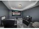 Home theater room with theater screen showing an NFL game and black leather recliners at 149 Crown Glen Way, Stockbridge, GA 30281