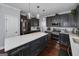 Modern kitchen featuring an island, stainless steel appliances, and dark cabinets at 149 Crown Glen Way, Stockbridge, GA 30281