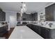 Stylish kitchen with an island, dark cabinets, modern appliances, and ample counter space for cooking at 149 Crown Glen Way, Stockbridge, GA 30281