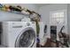 Laundry room featuring a washer, dryer, and shelving for storage at 149 Crown Glen Way, Stockbridge, GA 30281