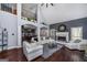 Comfortable living room with a fireplace, high ceiling, wood floors, and seamless flow to the kitchen at 149 Crown Glen Way, Stockbridge, GA 30281