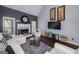 Cozy living room features a fireplace, large windows, and comfortable seating, perfect for relaxation at 149 Crown Glen Way, Stockbridge, GA 30281