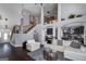 Bright, open living area featuring dark wood floors, a staircase, and seamless flow to the kitchen at 149 Crown Glen Way, Stockbridge, GA 30281