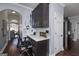 Hallway office nook with built-in desk and cabinets, stainless steel refrigerator nearby at 149 Crown Glen Way, Stockbridge, GA 30281