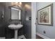 Elegant powder room with pedestal sink and decorative mirror at 149 Crown Glen Way, Stockbridge, GA 30281