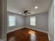 Bedroom with hardwood floors, ceiling fan, and natural light from two windows at 1165 Fair Sw St, Atlanta, GA 30314