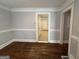 Dining room with hardwood floors, wainscotting detail, and a view into the hall and rear at 1165 Fair Sw St, Atlanta, GA 30314