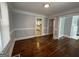 Spacious dining area with hardwood floors and views into the kitchen and living room at 1165 Fair Sw St, Atlanta, GA 30314