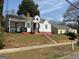 Street view of a white house with a red foundation, with steps leading to the front entrance at 1165 Fair Sw St, Atlanta, GA 30314