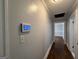 Hallway featuring hardwood floors, neutral-colored walls, and a wall-mounted control panel at 1165 Fair Sw St, Atlanta, GA 30314